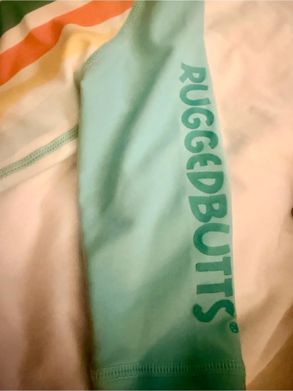 Rugged Butts Kids Front-Zip Rashguard Sunsuit in Aqua with Multi Stripes